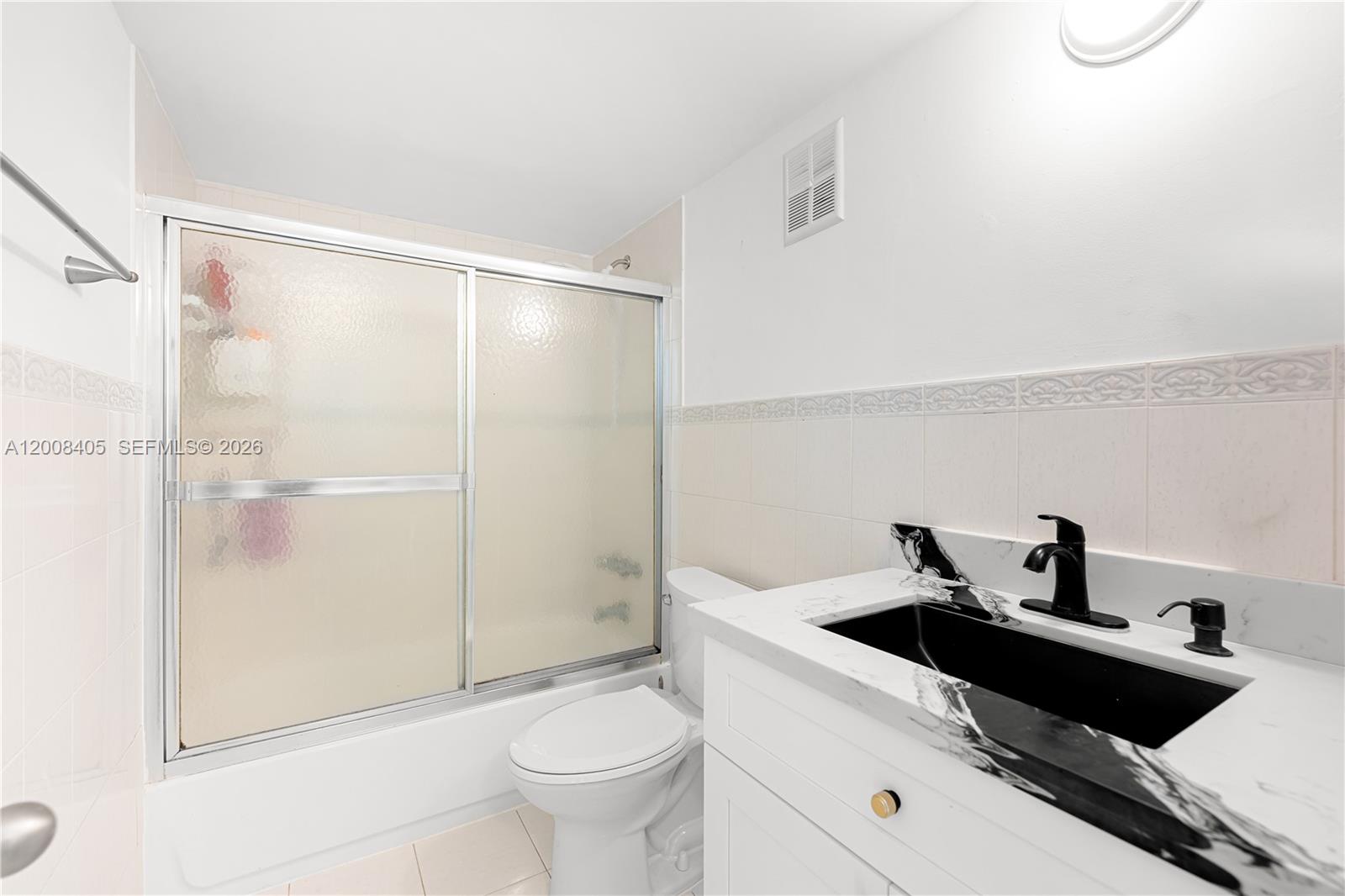 6195 Rock Island Road, Unit 503 Tamarac, FL 33319 - Photo 15 of 29 a bathroom with a sink toilet and shower
