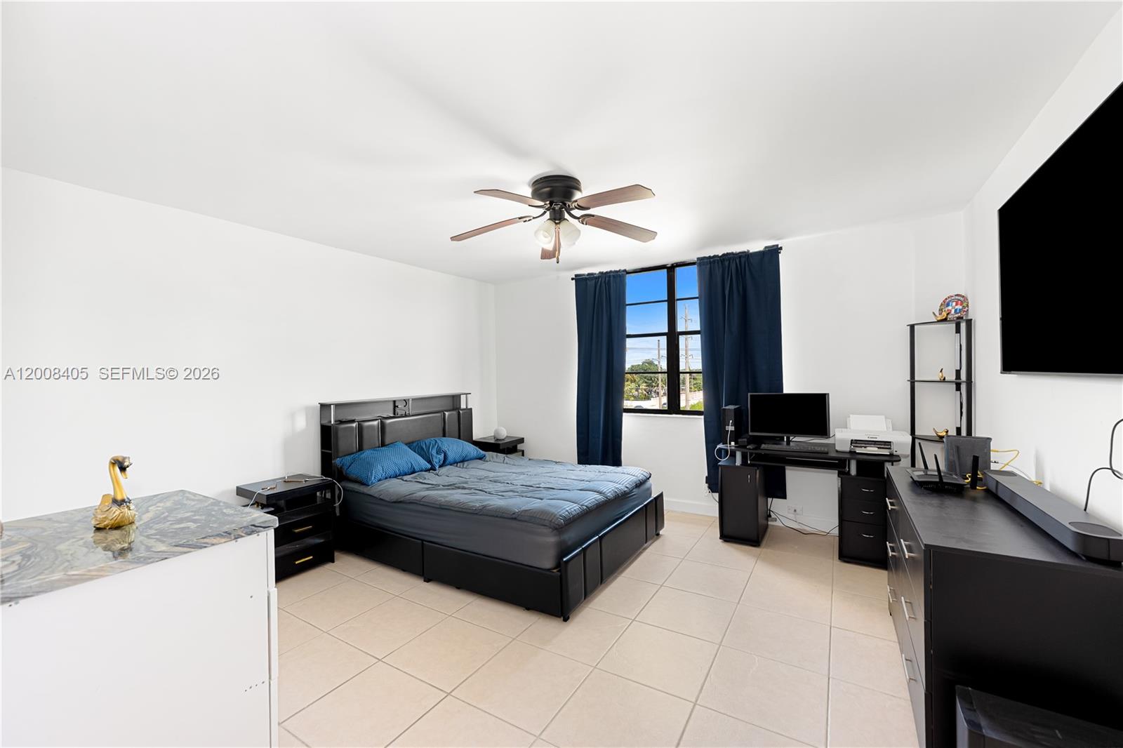 6195 Rock Island Road, Unit 503 Tamarac, FL 33319 - Photo 17 of 29 a living room with furniture and a flat screen tv