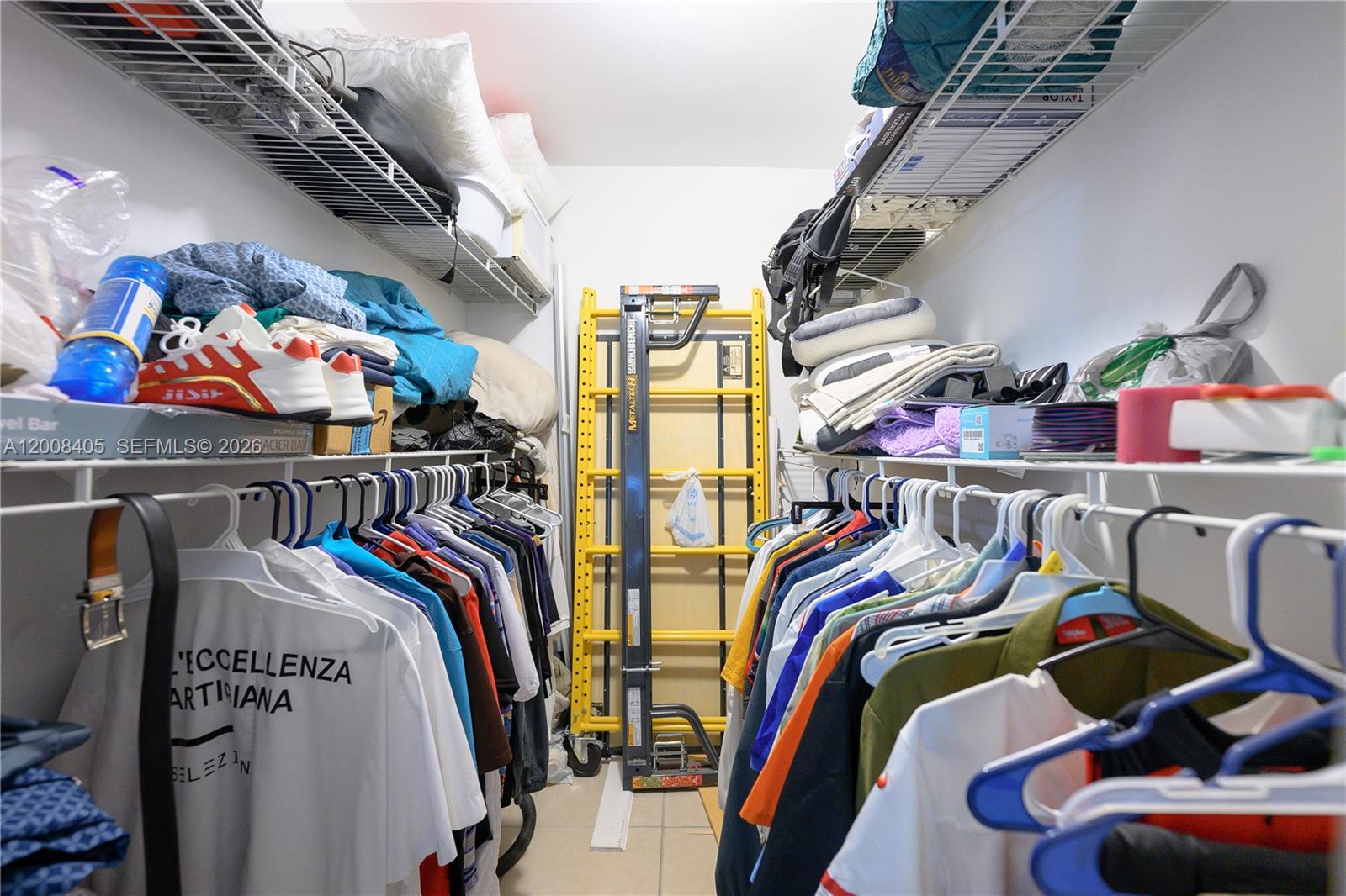 6195 Rock Island Road, Unit 503 Tamarac, FL 33319 - Photo 21 of 29 a view of walk in closet with clothes and shoes
