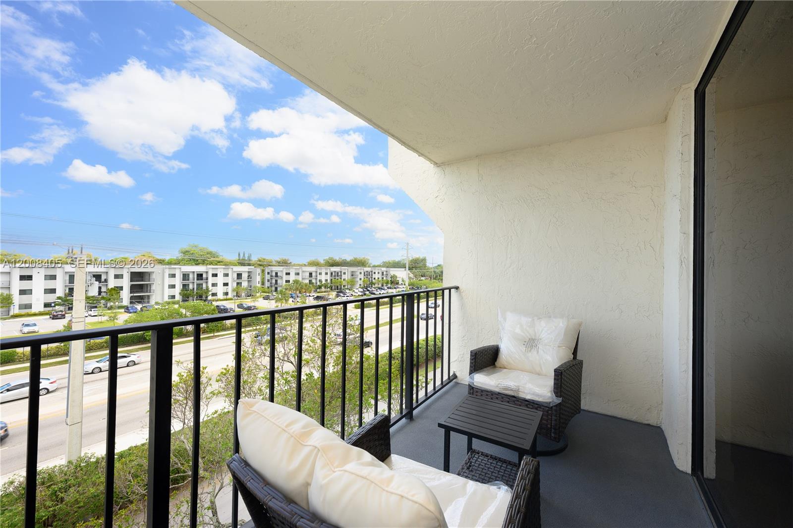 6195 Rock Island Road, Unit 503 Tamarac, FL 33319 - Photo 23 of 29 a view of a city from a balcony with furniture