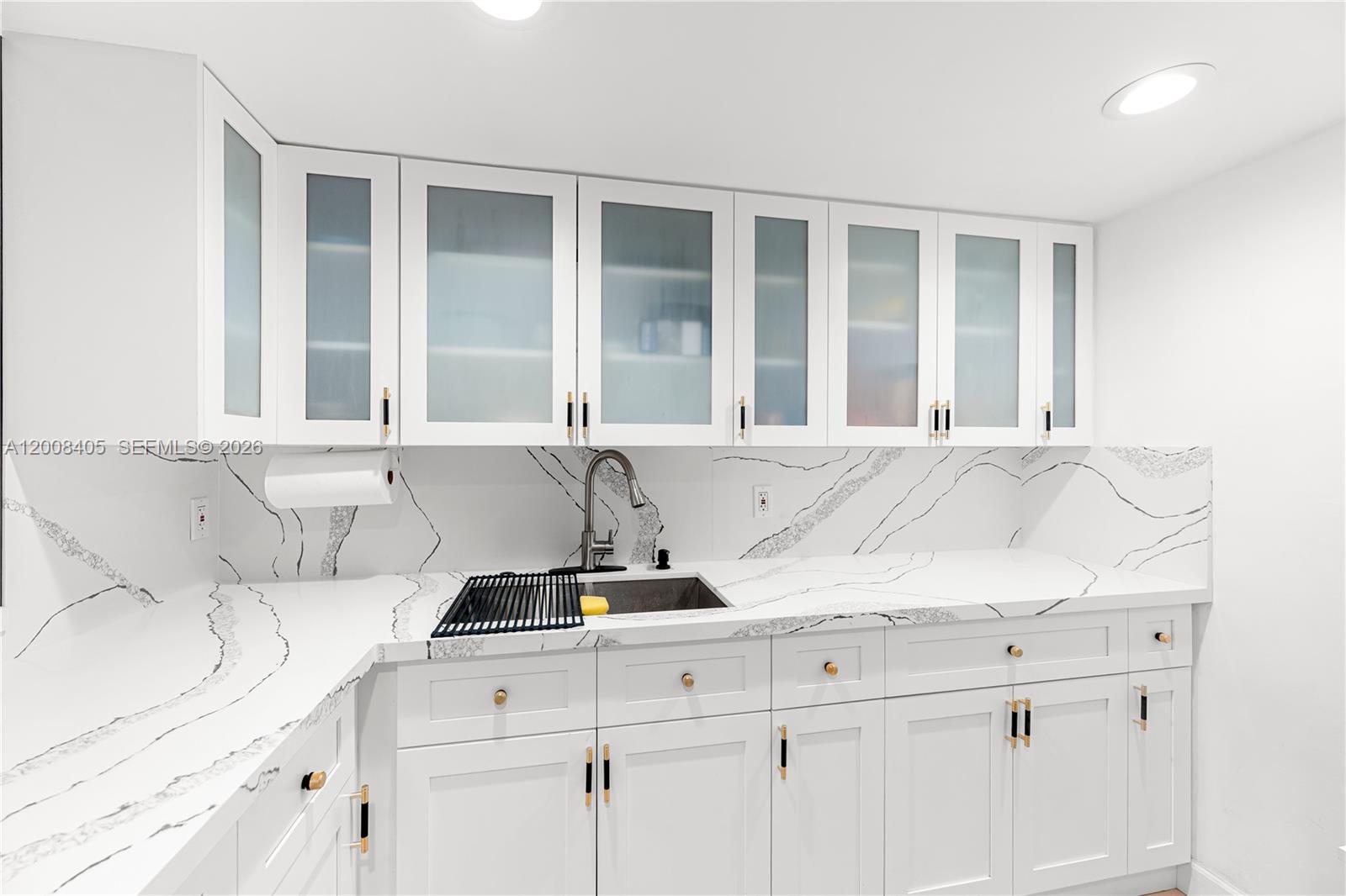 6195 Rock Island Road, Unit 503 Tamarac, FL 33319 - Photo 3 of 29 a kitchen with a sink and cabinets