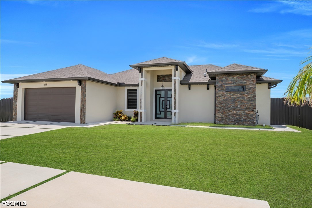 1128 Nelson Road North Cape Coral, FL 33993 - Photo 3 of 22 a front view of house with yard