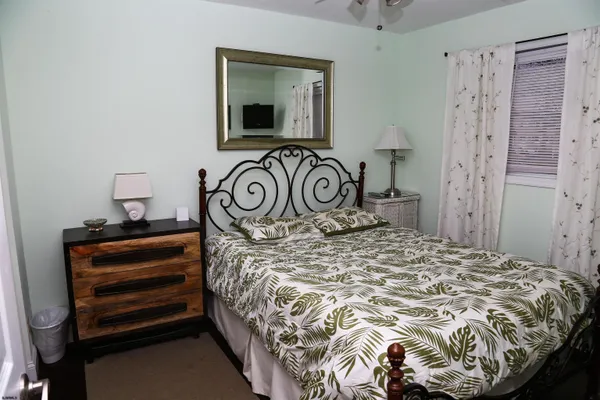 a bedroom with a bed and a tv