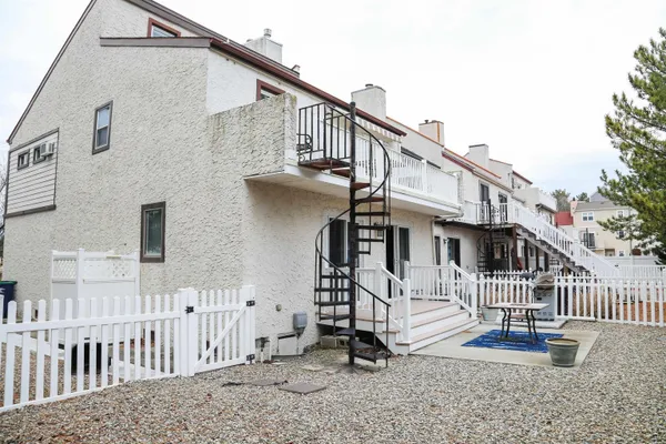 a view of a house with a small yard and stairs