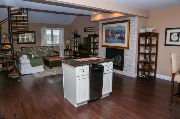 a view of a kitchen with furniture and wooden floor