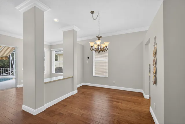 a view of a room with wooden floor and chandelier