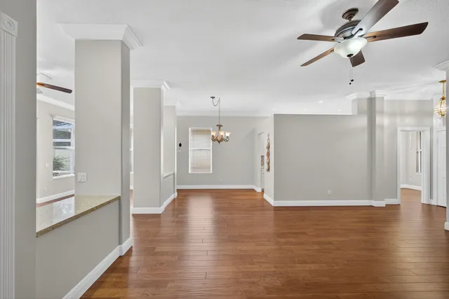 a view of an empty room with wooden floor