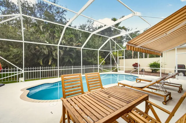 a view of a patio with a table and chairs