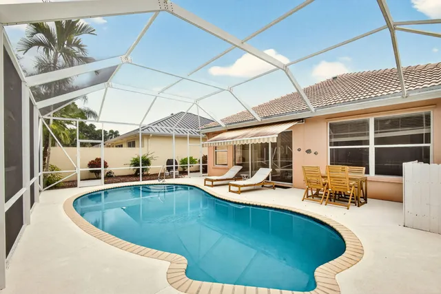 a view of a swimming pool with outdoor seating