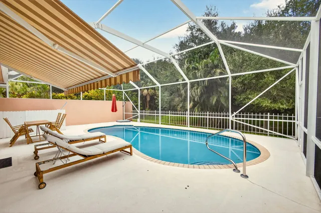 a view of a swimming pool with a lounge chair