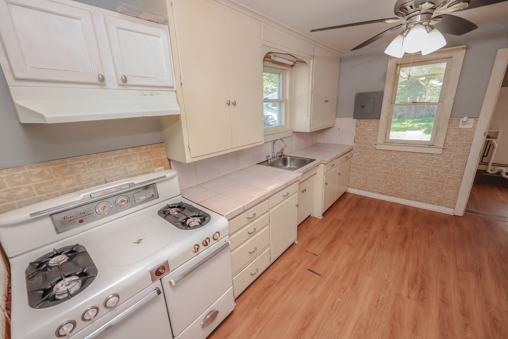 200 South Park Road Joliet, IL 60433 - Photo 4 of 11 a kitchen with a stove and a wooden floor