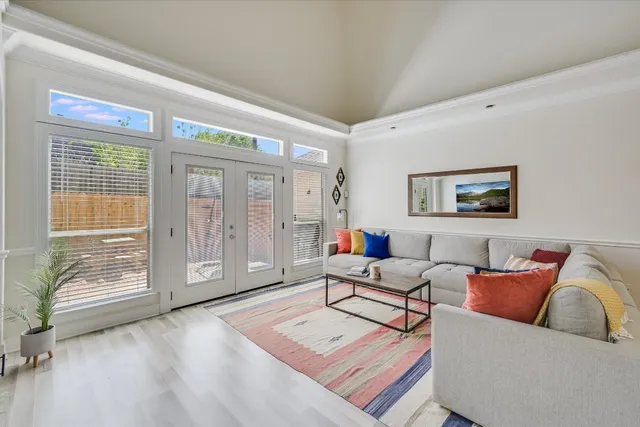a living room with furniture and a floor to ceiling window