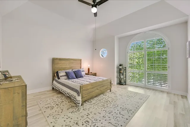 a bedroom with a bed and large window