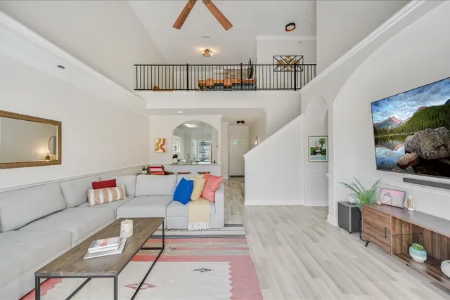 a living room with furniture and a wooden floor