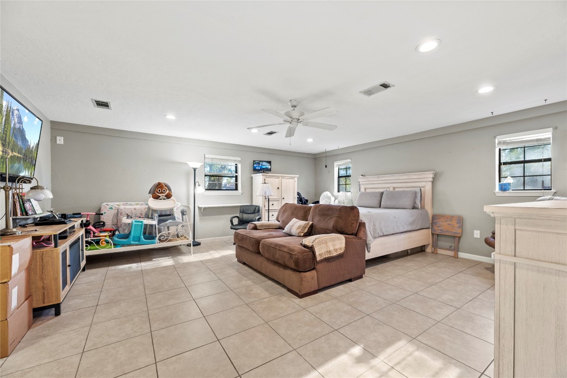 1203 Lemm Road 2 Spring, TX 77373 - Photo 21 of 21 This massive third bedroom showcases the versatility of the home’s floor plan. Featuring easy-to-maintain tile flooring and bright recessed lighting, this expansive space is large enough to serve as a secondary living area or a guest suite.