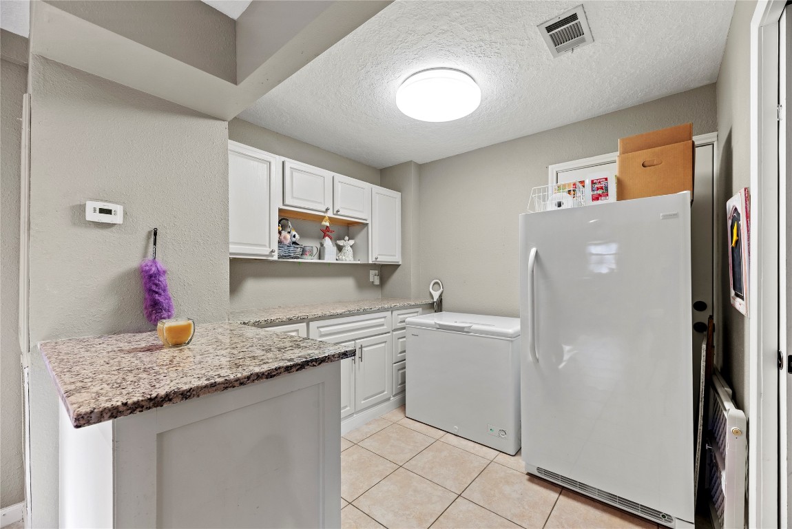 1203 Lemm Road 2 Spring, TX 77373 - Photo 14 of 21 The oversized utility room features durable granite countertops and custom cabinetry for a coordinated, high-end look. Designed for maximum functionality, this space offers ample room for storage to keep your home organized and clutter-free.