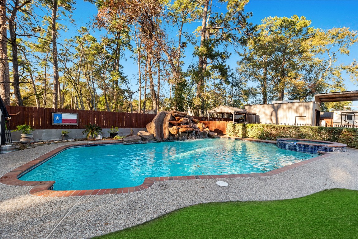 1203 Lemm Road 2 Spring, TX 77373 - Photo 15 of 21 Escape to your private oasis featuring an in-ground pool with a rock waterfall and integrated slide, the perfect summer retreat.
