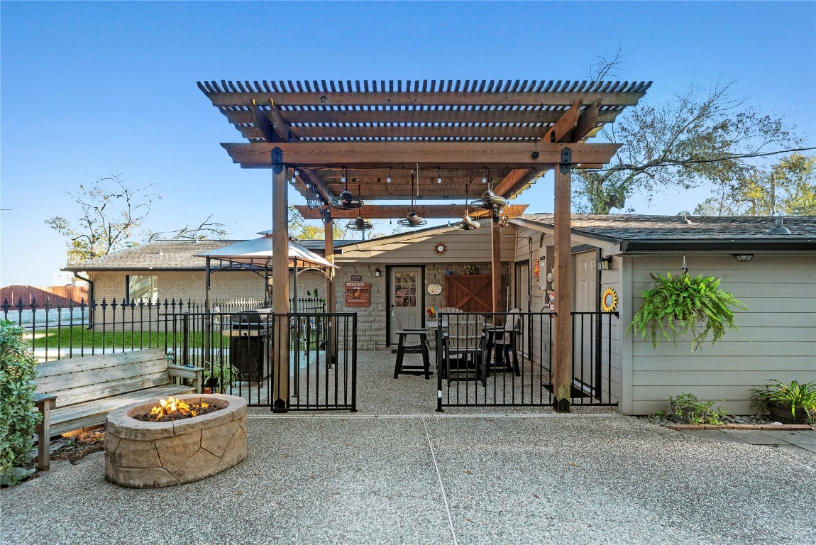 1203 Lemm Road 2 Spring, TX 77373 - Photo 16 of 21 The heavy-timber pergola with ceiling fans and string lights is the ultimate setting for entertaining, overlooking a built-in stone fire pit.