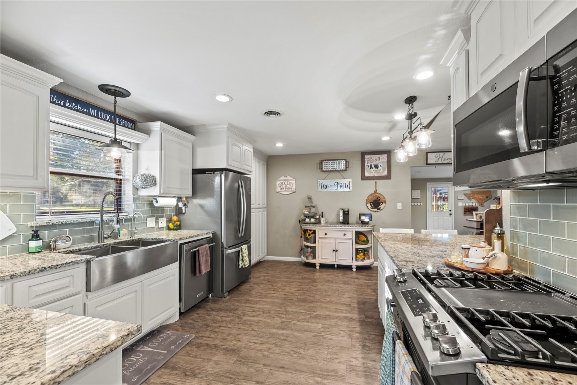 1203 Lemm Road 2 Spring, TX 77373 - Photo 8 of 21 High-function meets style with a gas range, gas oven, and a deep stainless steel farmhouse sink complemented by under-cabinet lighting.