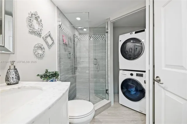 a bathroom with a toilet a sink and a shower