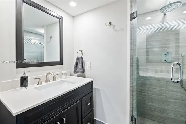 a bathroom with a sink a vanity a mirror and shower