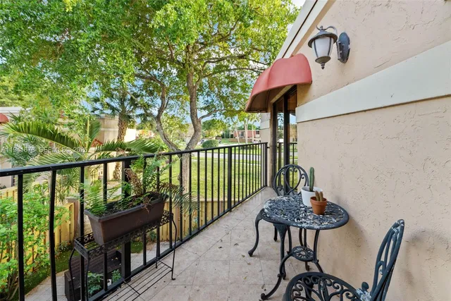 a view of a balcony with chairs