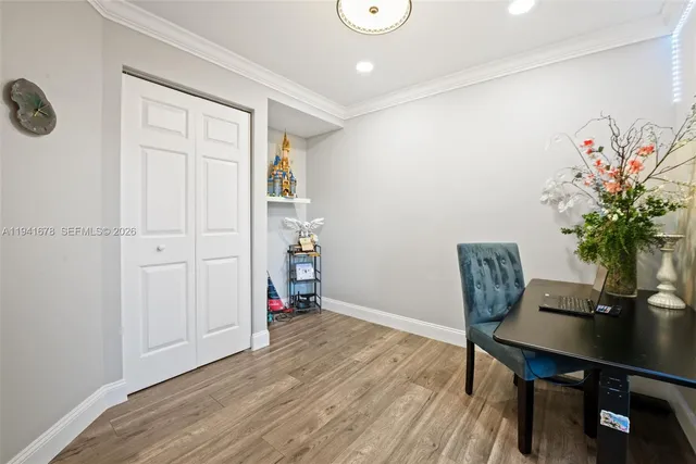 a view of a workspace with furniture and wooden floor