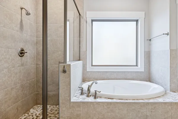 a bathroom with double vanity and a mirror