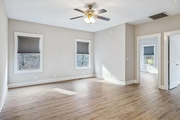 wooden floor in an empty room with a window