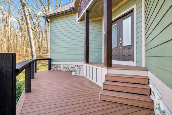 a kitchen with stainless steel appliances kitchen island granite countertop a refrigerator a stove a microwave oven a dining table and chairs with wooden floor