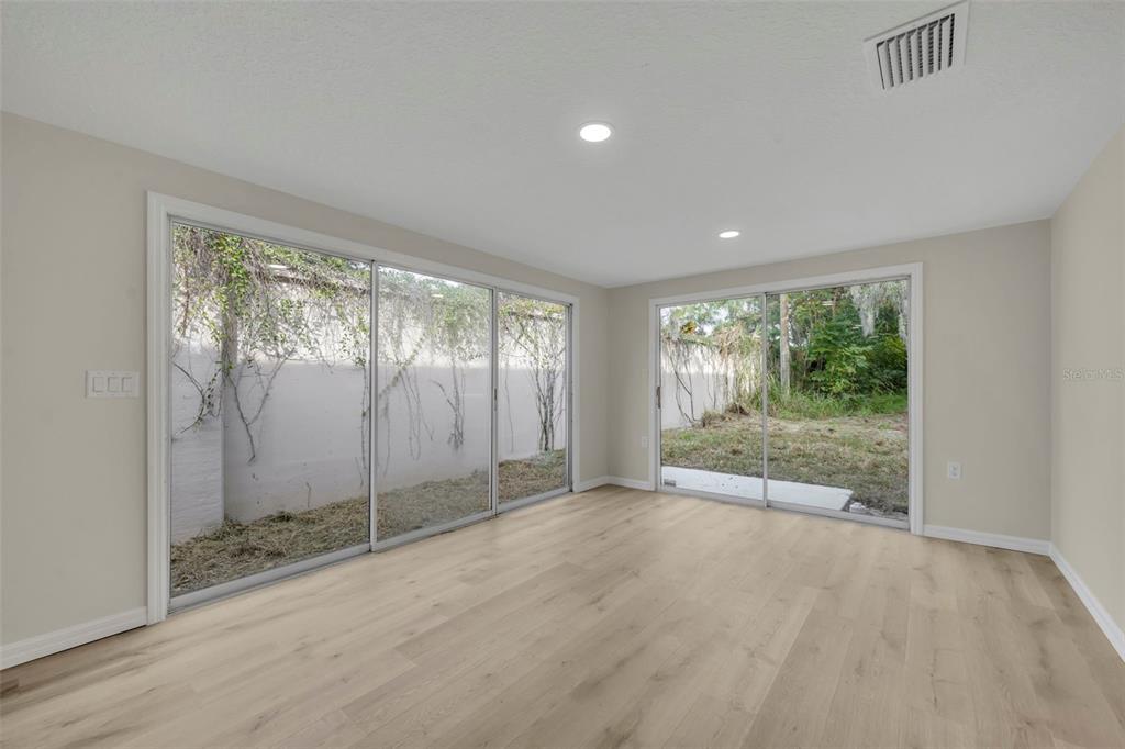31201 Merry Road Tavares, FL 32778 - Photo 13 of 40 a view of an empty room with glass door