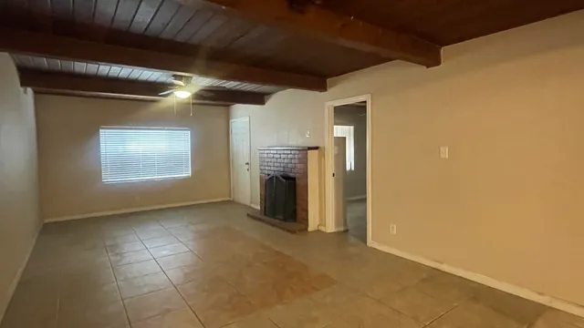 a view of empty room with a fireplace