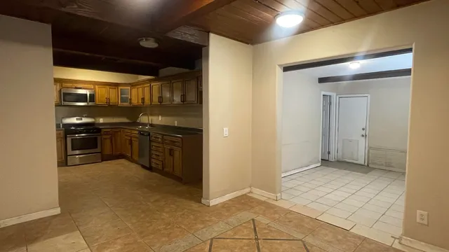 a view of a kitchen with a sink and cabinets
