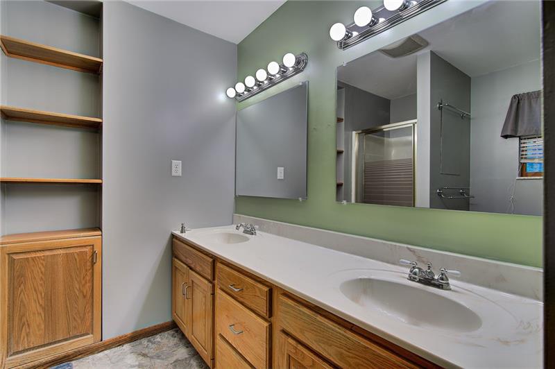 112 Wycliffe Way Butler, PA 16001 - Photo 12 of 24 Master bath freshly painted with double sink large mirrors and excellent lighting. Built-in shelves. The shower is across from the far sink (see it in the mirror!). Toilet is next to it under the window you see in the mirror. This room is in the back of the house.