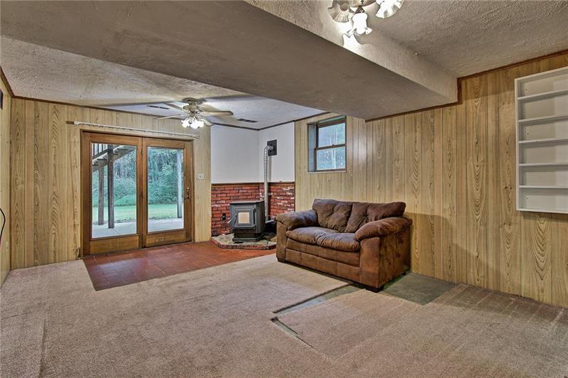 112 Wycliffe Way Butler, PA 16001 - Photo 17 of 24 Welcome to your new den/man cave/family room or ???. Working pellet stove with double doors to the patio. And yes, those sweet ceiling fans are included. Not sure what's up with that carpet...weird. This room is in the back of the house under the dining room.