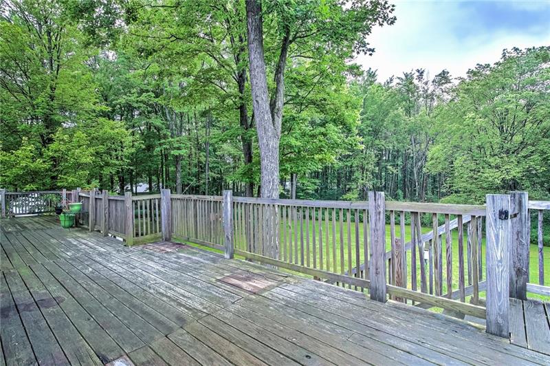 112 Wycliffe Way Butler, PA 16001 - Photo 23 of 24 The huge back deck runs the length of the house. Stairs lead to the concrete patio below. Perfect for cooks out with the whole darn neighborhood. Except for that one neighbor. You know who I mean.