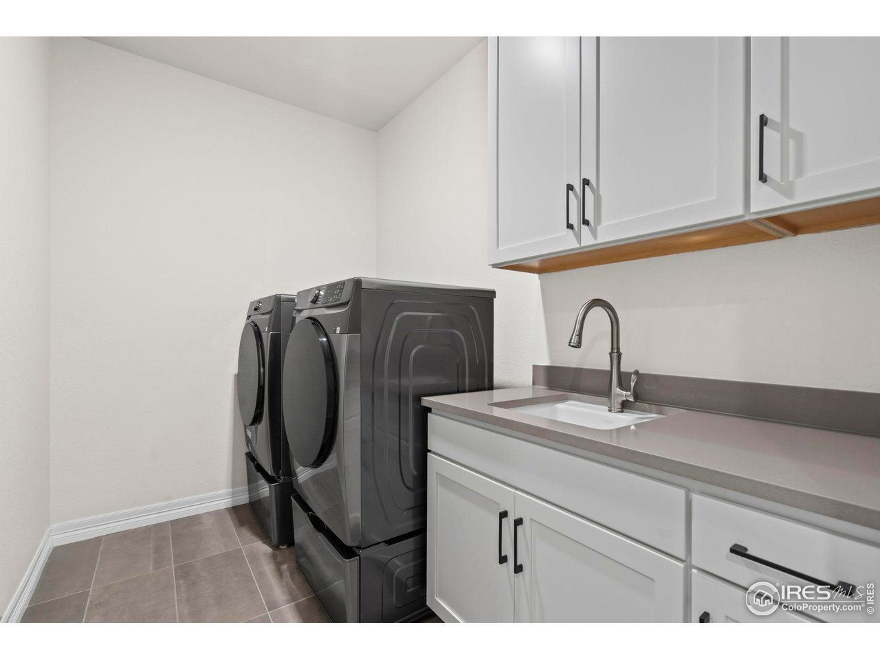 4344 Shivaree Court Timnath, CO 80547 - Photo 37 of 41 Laundry room with sink and lots of storage