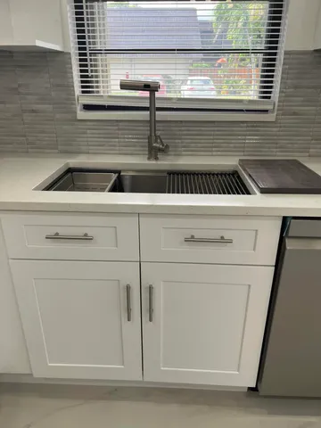 a kitchen with a sink and a window