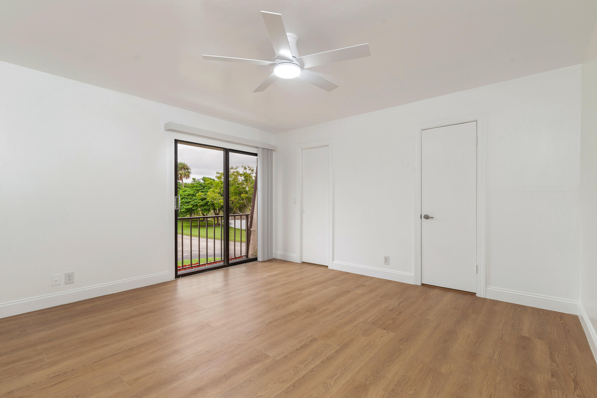 326 Jupiter Lakes Boulevard, Unit 2310B Jupiter, FL 33458 - Photo 24 of 48 wooden floor in an empty room with a window
