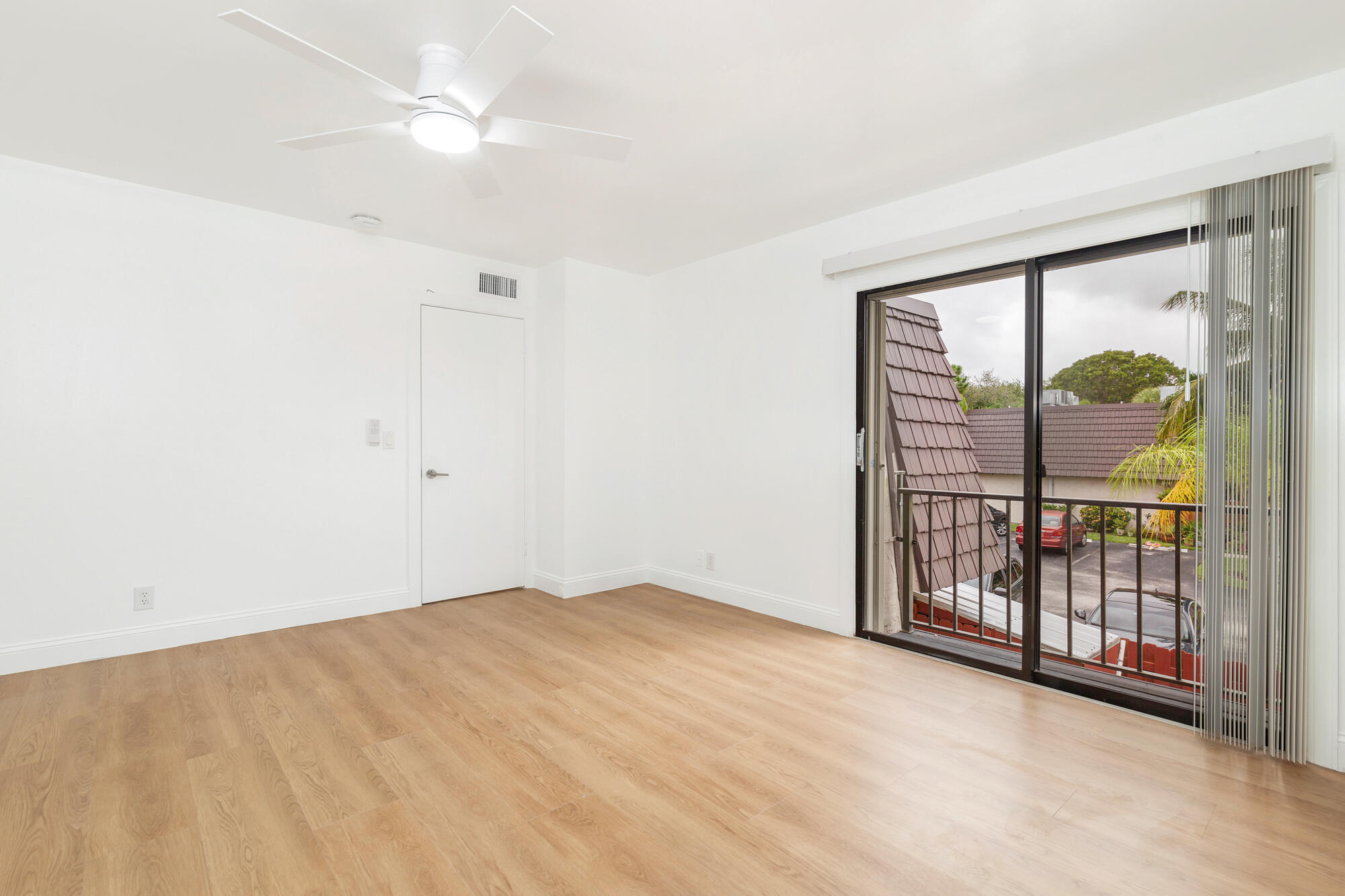 326 Jupiter Lakes Boulevard, Unit 2310B Jupiter, FL 33458 - Photo 25 of 48 an empty room with windows and fan