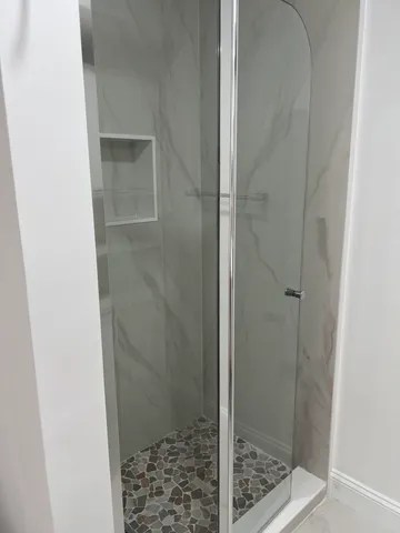 a bathroom with a glass shower door
