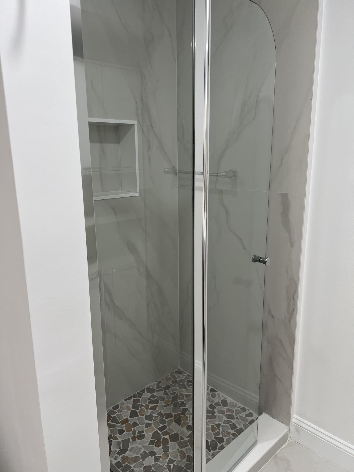 326 Jupiter Lakes Boulevard, Unit 2310B Jupiter, FL 33458 - Photo 27 of 48 a bathroom with a glass shower door