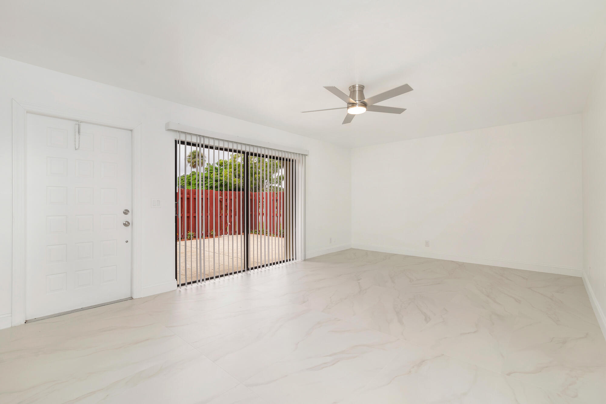 326 Jupiter Lakes Boulevard, Unit 2310B Jupiter, FL 33458 - Photo 3 of 48 an empty room with fan