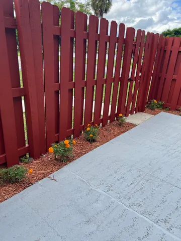 a view of a pathway with a wooden fence