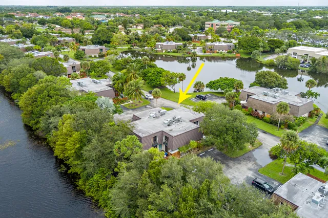an aerial view of lake and residential houses with outdoor space