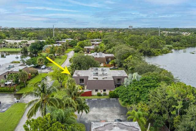 an aerial view of a house with a lake view