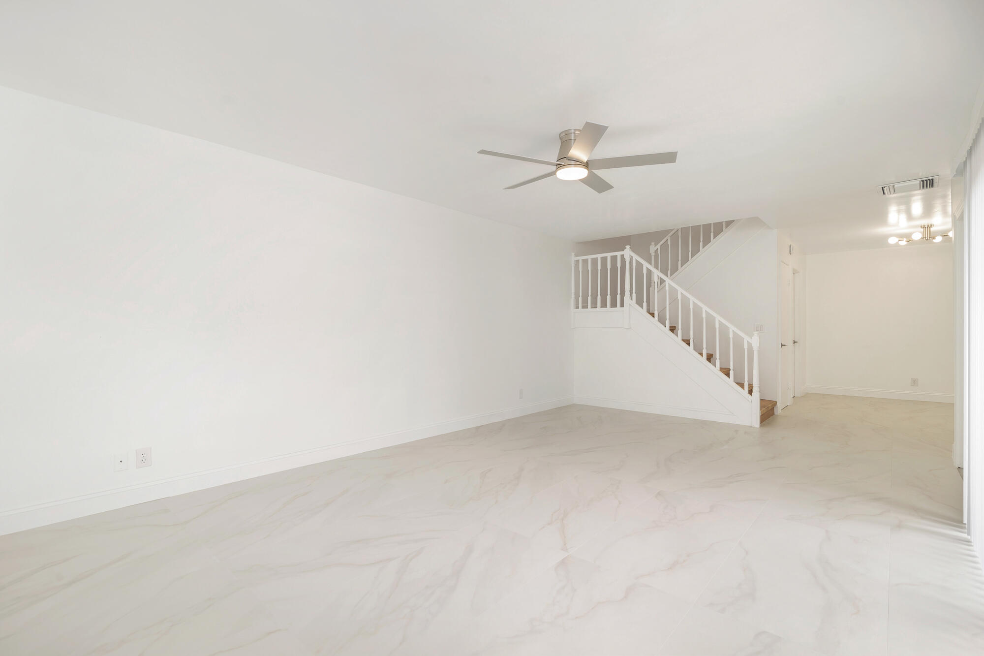 326 Jupiter Lakes Boulevard, Unit 2310B Jupiter, FL 33458 - Photo 5 of 48 a view of an empty room with a chandelier fan