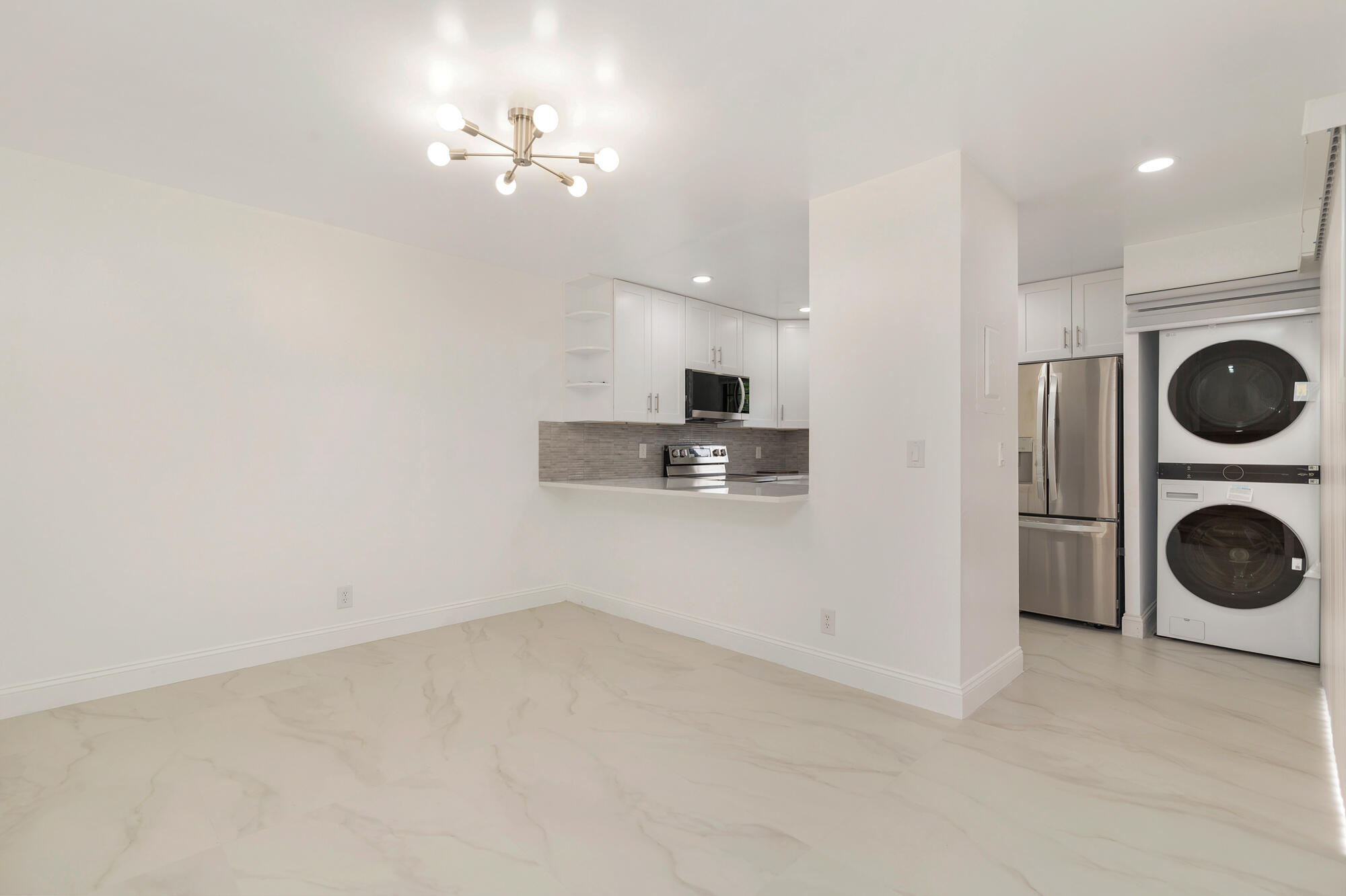 326 Jupiter Lakes Boulevard, Unit 2310B Jupiter, FL 33458 - Photo 9 of 48 a view of a washer and dryer in a room