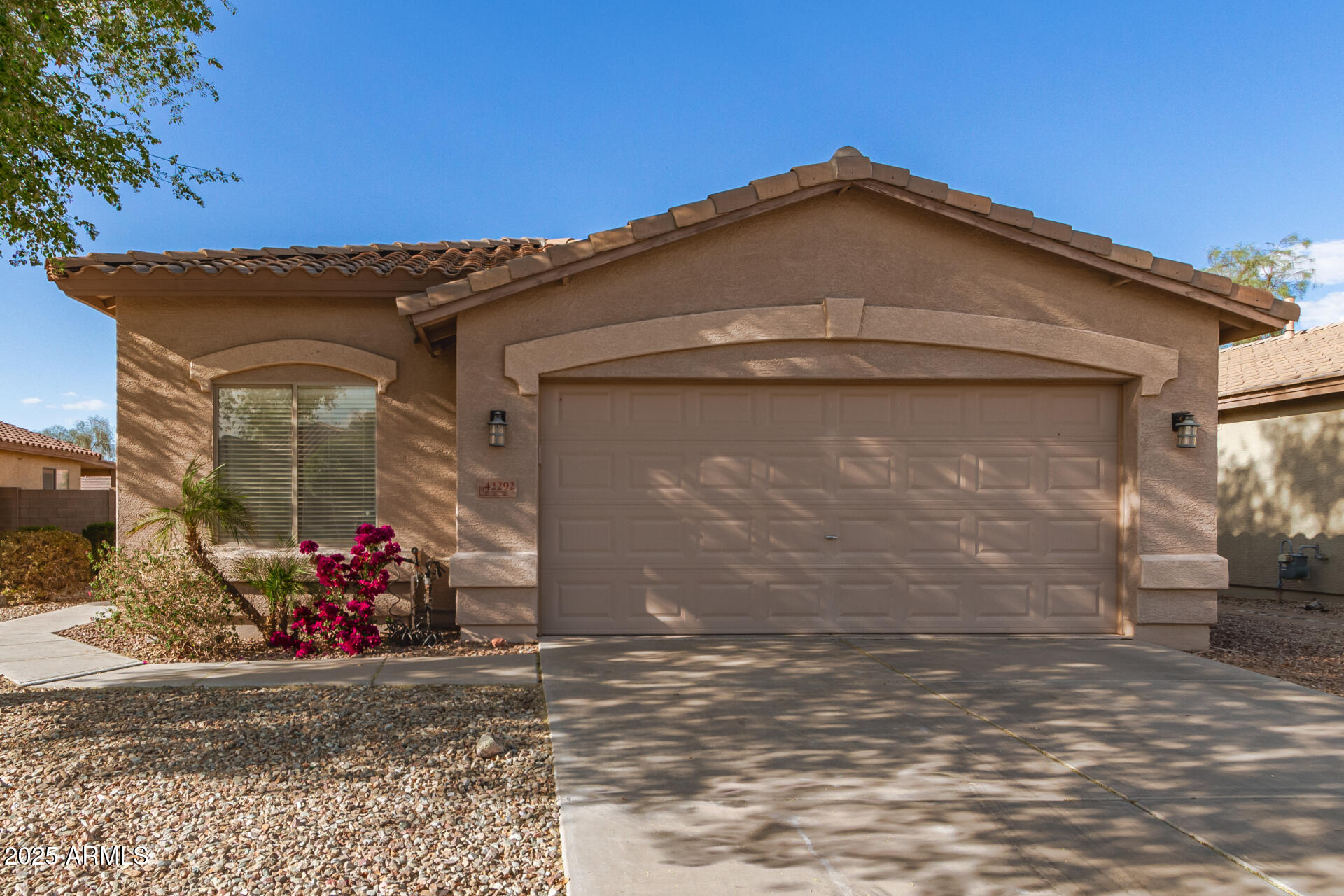 42292 West Venture Road Maricopa, AZ 85138 - Photo 3 of 27 a front view of a house with a yard