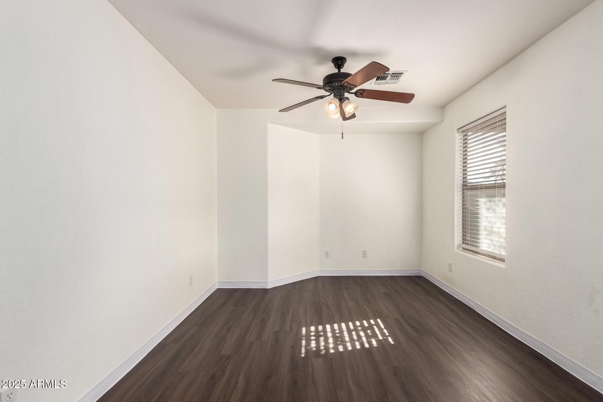 42292 West Venture Road Maricopa, AZ 85138 - Photo 6 of 27 a view of empty room with wooden floor and fan